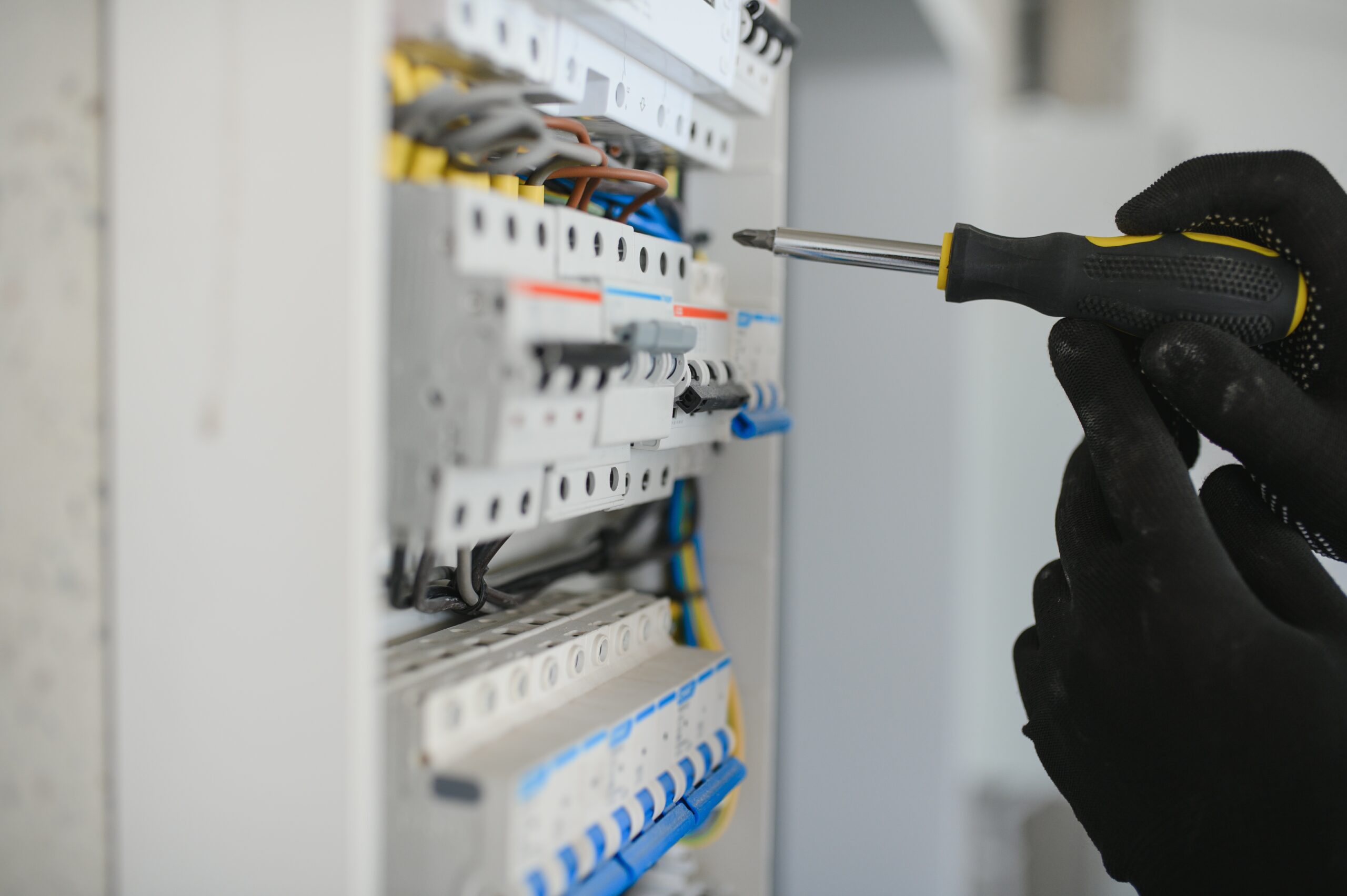Close-up of electrician working on circuitry Close-up of electrician working on circuitry